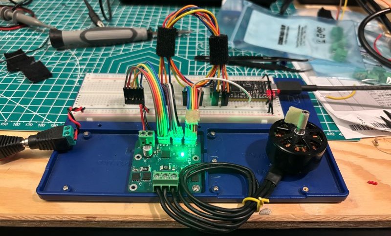 The DRV8303 PCB connected to a BLDC motor and a microcontroller on a breadboard.